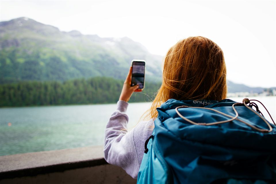 A traveller checking her phone with a data connection abroad